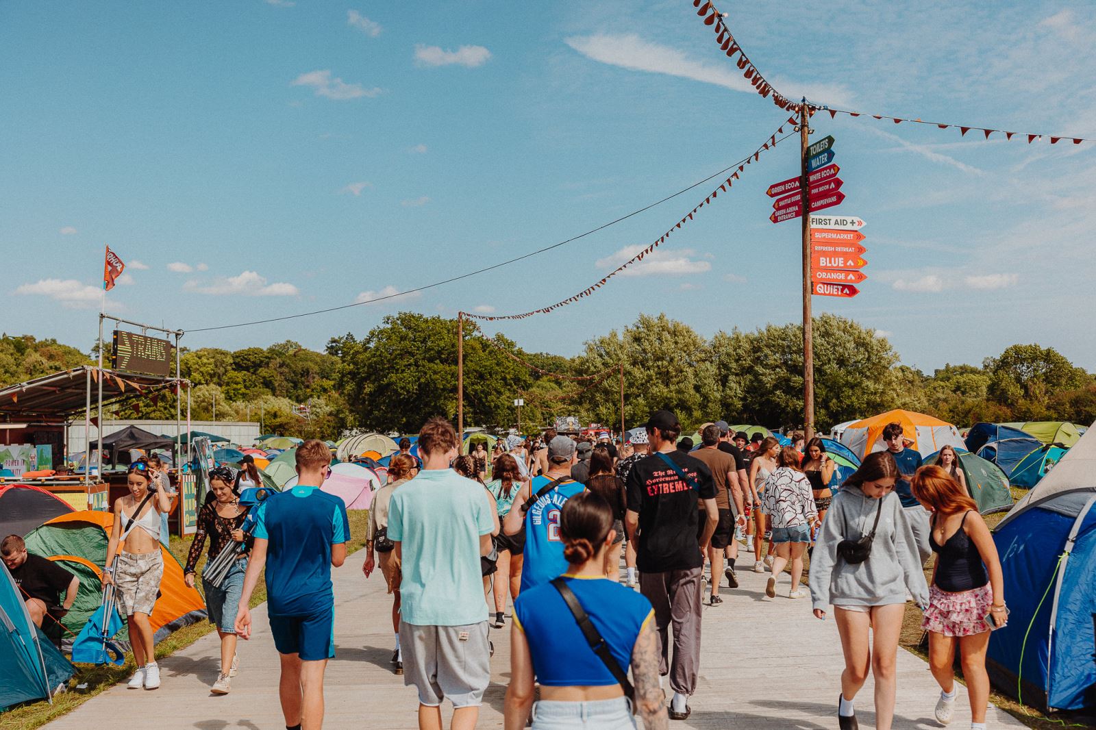 Young people walking through festival campsites